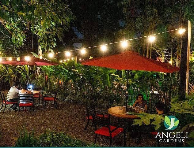 Outdoor garden tables under string lights at Angeli Gardens Restaurant